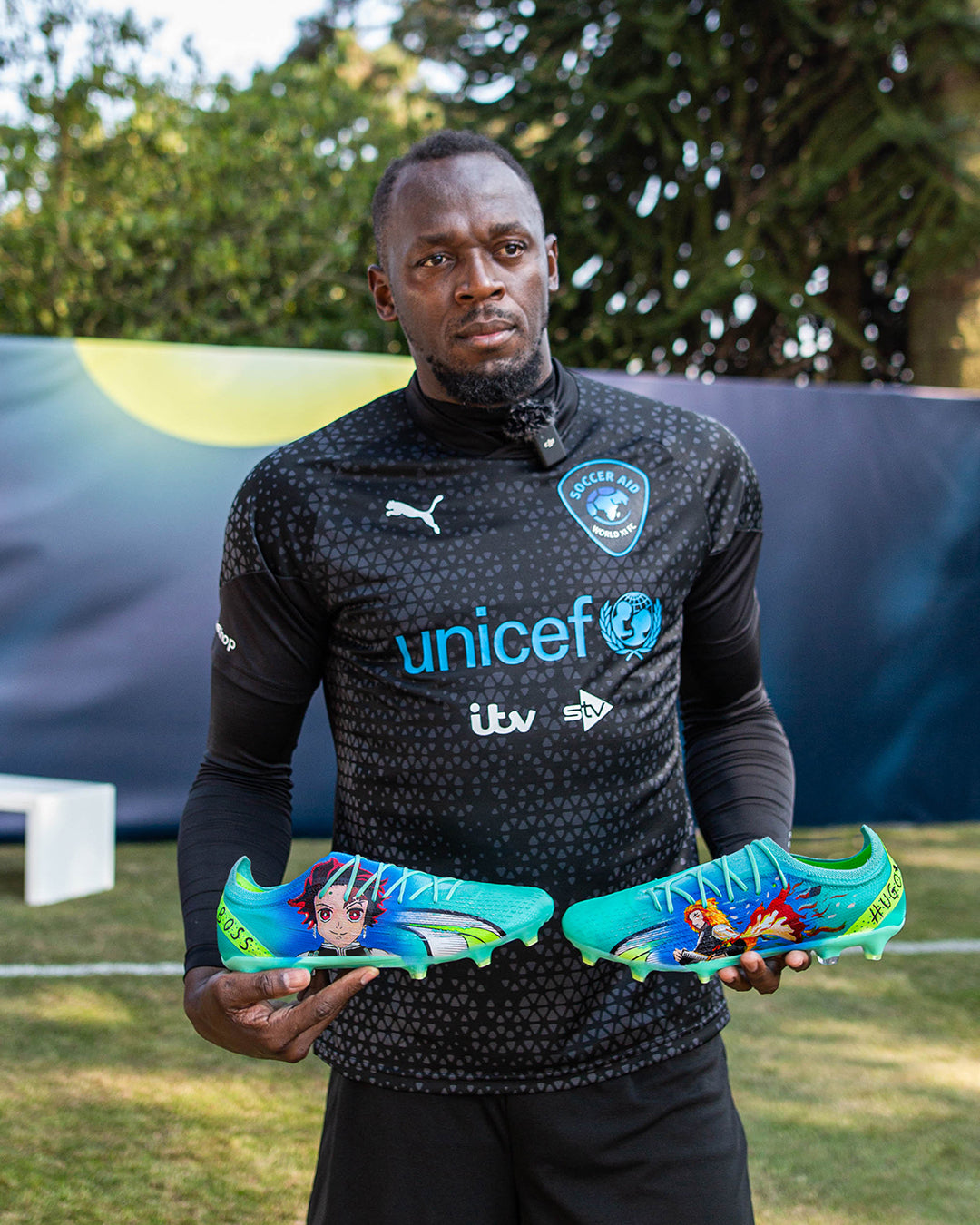 Usain Bolt with his custom anime football boots created by CANVVS